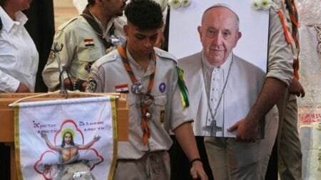 Egyptian boy scouts carry a portrait of the late Pope Francis during a service at Holy Virgin Mary Coptic Catholic Cathedral, in Cairo, April 22, 2025. (AP Photo/Amr Nabil)