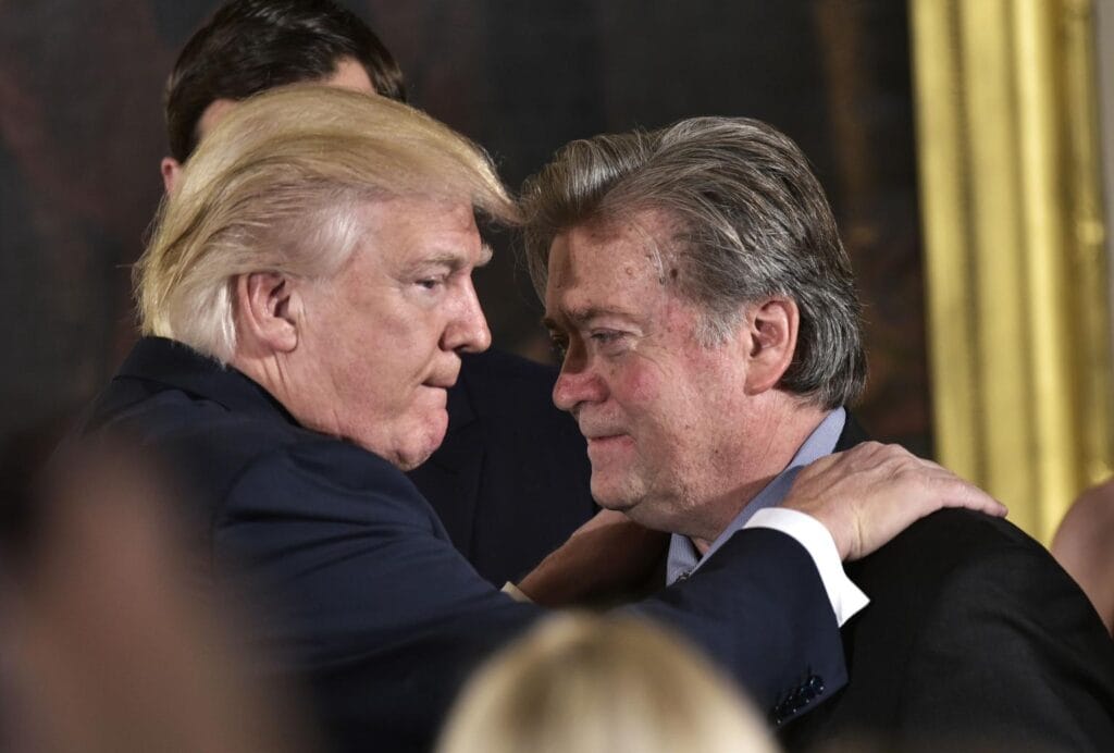 This file photo taken on January 22, 2017 shows US President Donald Trump (L) congratulating Senior Counselor to the President Stephen Bannon during the swearing-in of senior staff in the East Room of the White House in Washington, DC.AFP/Getty Images