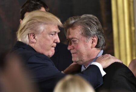 This file photo taken on January 22, 2017 shows US President Donald Trump (L) congratulating Senior Counselor to the President Stephen Bannon during the swearing-in of senior staff in the East Room of the White House in Washington, DC.AFP/Getty Images