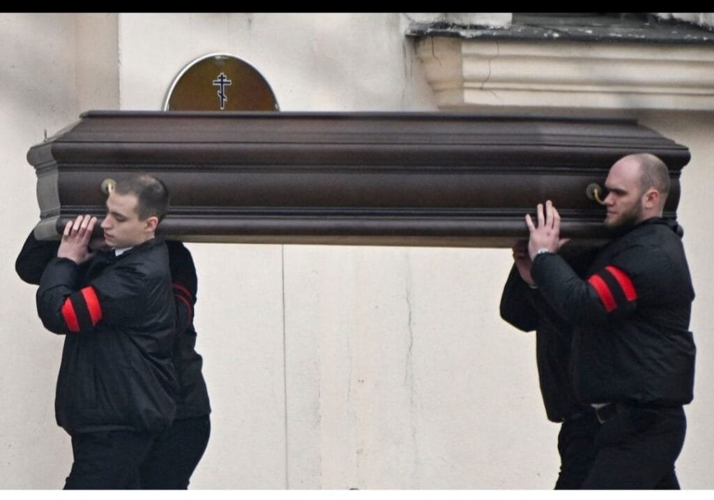 Pallbearers carry the coffin of late Russian opposition leader Alexei Navalny into the Mother of God Quench My Sorrows church for his funeral service in Moscow's district of Maryino on Friday. (Alexander Nemenov/AFP/Getty Images)