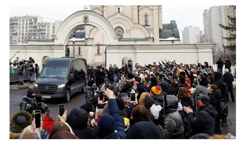A hearse carrying the body of Russian opposition leader Alexei Navalny is parked outside a church in Moscow on Friday before his funeral. (Stringer/Reuters)
