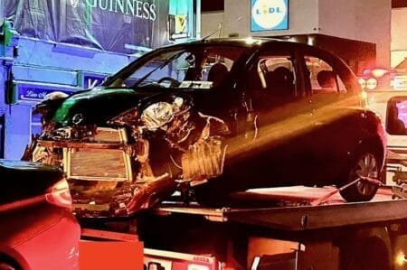 One of the damaged vehicles is removed from the scene. (Image: David Raleigh)