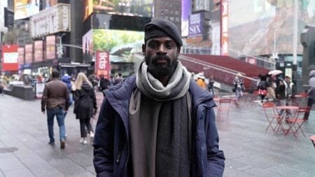Tunde Onakoya, 29- years old, a Nigerian chess champion and child education advocate, poses on the street in Times Square, New York, April, 18, 2024.