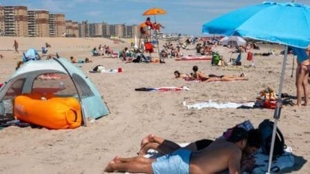People enjoy a day at Rockaway Beach. (Photo by Spencer Platt/Getty Images)