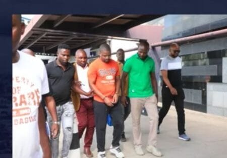 Peter Dube is led away after his arrest