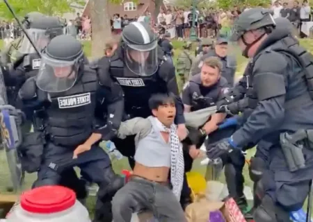 At least four law enforcement officers can be seen dragging away a protester at Indiana University.@ShirionOrg / X