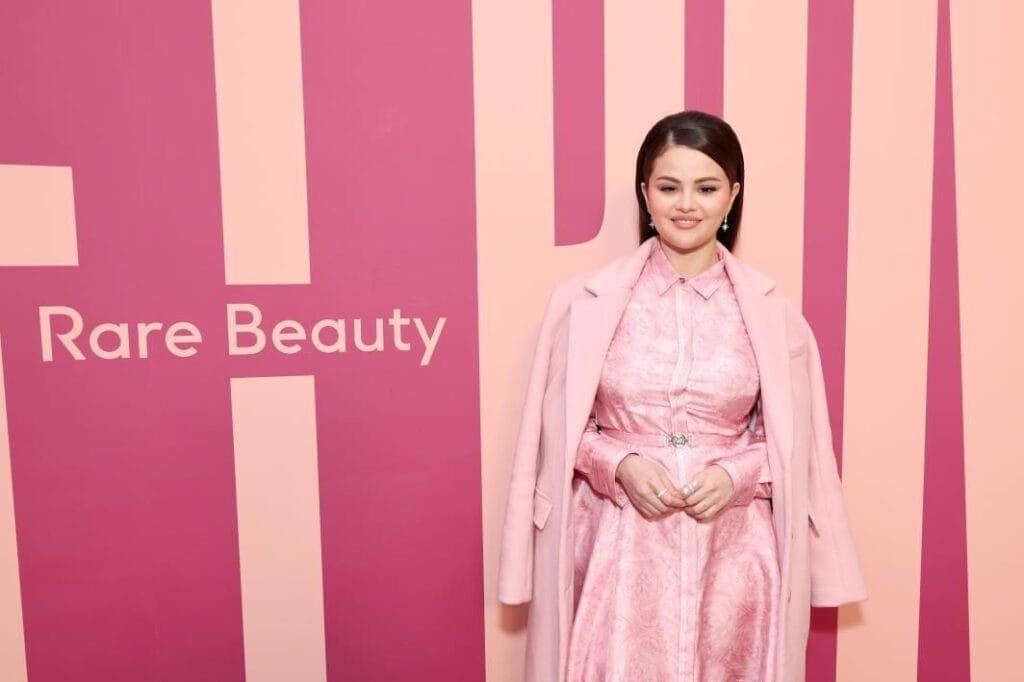 The pop star wore a Versace shirtdress.Getty Images for Rare Beauty