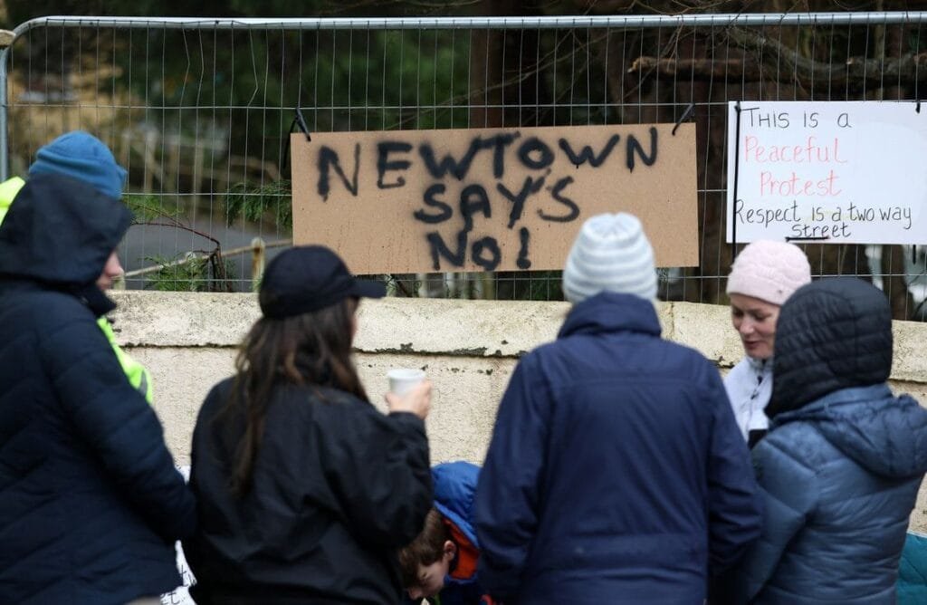 People march through Newtown protesting against the housing of asylum seekers nearby. © RollingNews.ie