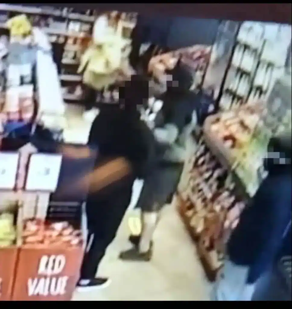 One man tackles a shop worker.