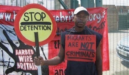 Anicet Mayela, who has pleaded guilty to raping a 15-year-old girl, wore a sign reading ‘migrants are not criminals’ (Picture: PA)