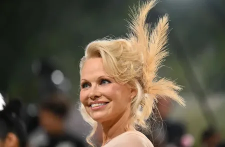 The Canadian star added a feathered headpiece to her undone updo to complete her glam.AFP via Getty Images