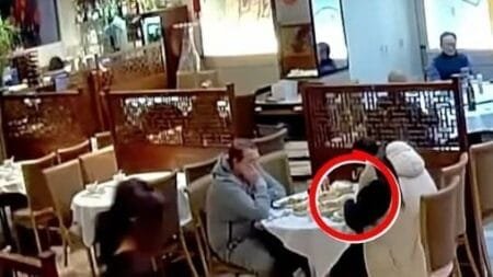 CCTV footage captures the woman planting hair in her food (Picture: Oriental Garden Restaurant Northampton)