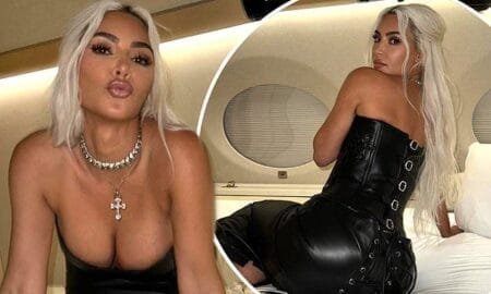 Kim Kardashian, 43, pouted as she put on on a busty display in a black corset while lounging on a bed in her private jet for photos shared to her Instagram on Wednesday