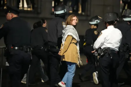 Protestors link arms as other police officers enter the campus of Columbia University on Tuesday night.REUTERS