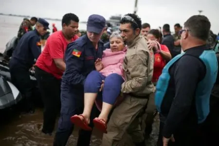 A woman was evacuated in Porto Alegre, in Rio Grande do Sul, Brazil, after the devastating floods (Picture: Renan Mattos/Reuters)