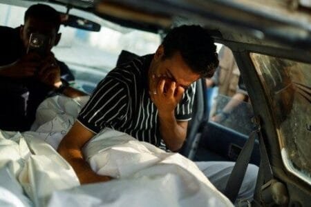 A Palestinian man cries at the sight of a killed loved one in Rafah (Picture: Reuters)