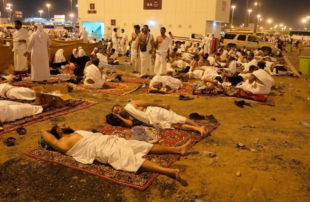 Muslims rest in Muzdalifah, on the second day of the annual hajj pilgrimage, near the holy city of Mecca. Alamy Stock Photo
