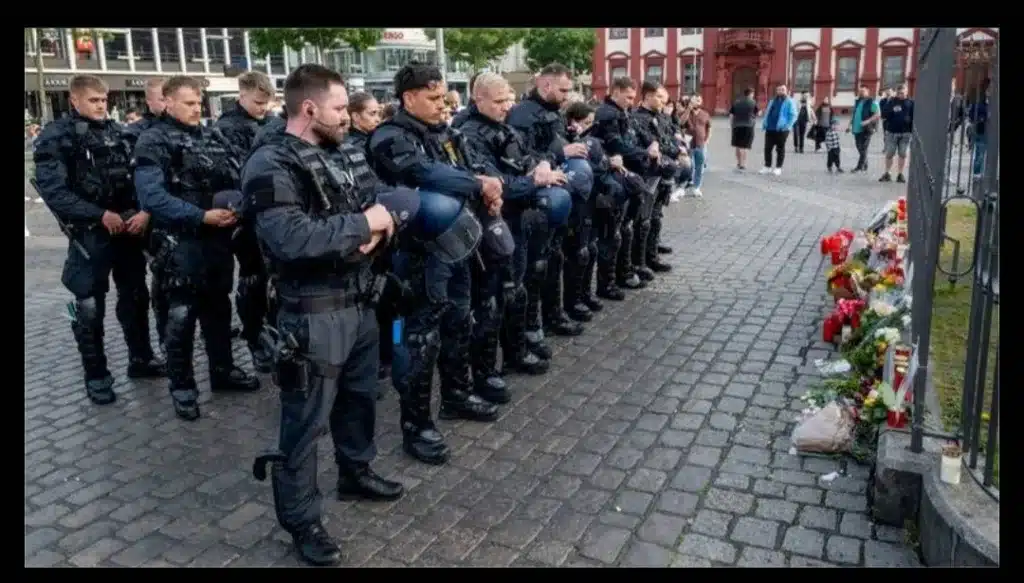Image:Police officers pay tribute to their colleague in Mannheim on Sunday. Pic: AP
