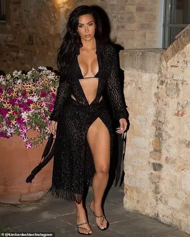 Kim Kardashian, 43, sizzled in a skimpy black bikini with a sheer sparkling black cover-up in a series on photos posted to her Instagram on Wednesday Kim Kardashian, 43, sizzled in a skimpy black bikini with a sheer sparkling black cover-up in a series on photos posted to her Instagram on Wednesday