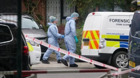 Forensic officers at an address in Shepherds Bush west London after human remains were found in two suitcases in Bristol