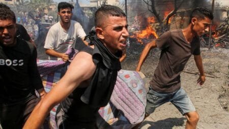 People carry a casualty following an Israeli strike in Khan Younis. Pic: Reuters.