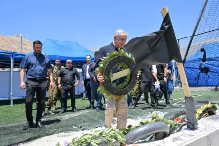 Israel’s Prime Minister Benjamin Netanyahu vowed a “harsh” response against Hezbollah while visiting the graves of the 12 youths killed on Saturday. Kobi Gideon/ GPO