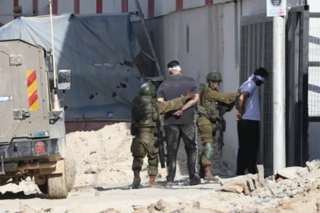Israeli soldiers arrest two Palestinian men during a raid in the Nur Shams camp for near the city of Tulkarem in the Israeli occupied West Bank on August 28 2024