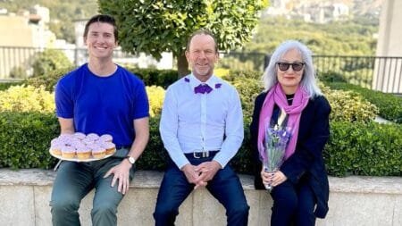 Australian ambassador Ian McConville centre poses with embassy staff to celebrate Wear It Purple Day