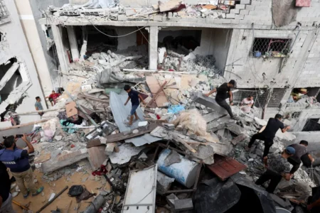 Palestinians inspect the site of an Israeli strike on a house amid the Israel Hamas conflict in Nuseirat in the central Gaza Strip on Sept 16 2024