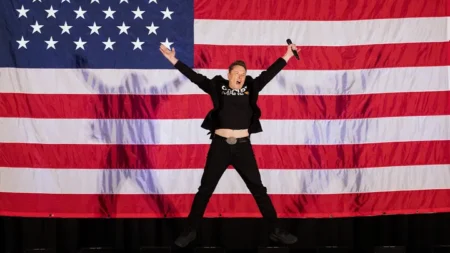 Elon Musk jumps on stage at a town hall event hosted by America PAC in support of former President Donald Trump at the Greater Philadelphia Expo Center in Oaks, Pennsylvania, on October 18, 2024. (Getty Images)