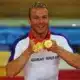 Hoy shows off his three medals he won at the 2008 Beijing Olympics