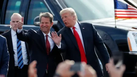 In this Nov. 4, 2018, file photo, then-Georgia Republican gubernatorial candidate Brian Kemp, left, walks with then-President Donald Trump as Trump arrives for a rally in Macon, Ga. (AP Photo/John Bazemore, File) (AP )