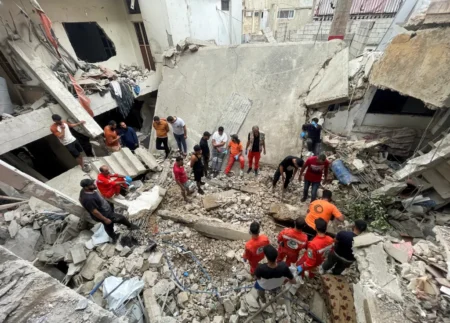 Rescuers and people inspect the site of a strike in Ain al-Hilweh refugee camp, near the southern city of Sidon. REUTERS