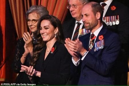 A bearded Prince William and Princess Kate were all smiles this evening as they clap as the performers take to the stage