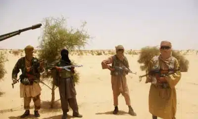 File In this Tuesday April 24 2012 file photo fighters from Islamist group Ansar Dine stand guard during a hostage handover in the desert outside Timbuktu Mali