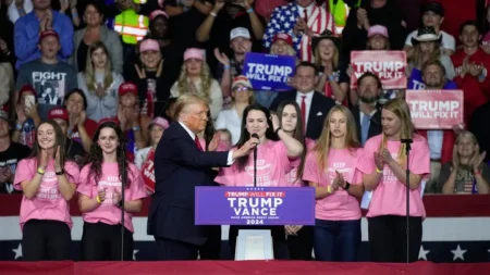 Lily Mullens of the Roanoke College women's swim team prepares to speak at a campaign rally for former President Trump, the Republican presidential nominee, Saturday Nov. 2, 2024, in Salem, Va. (AP Photo/Steve Helber)