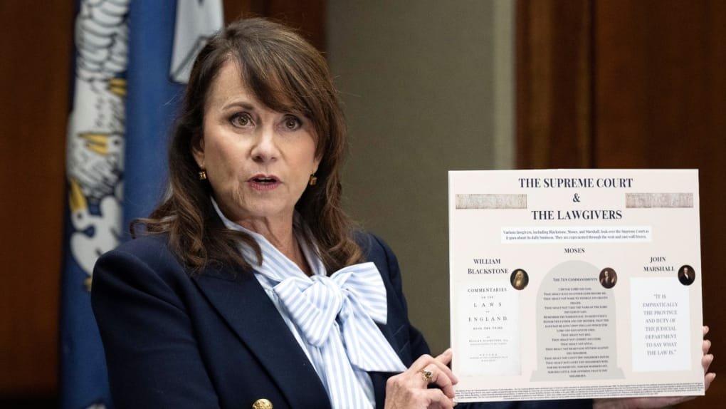 Louisiana Attorney General Liz Murrill holds up a mini display showing the Ten Commandments during a press conference regarding the Ten Commandments in schools, Aug. 5, 2024, in Baton Rouge, La. (Hilary Scheinuk/The Advocate via AP)