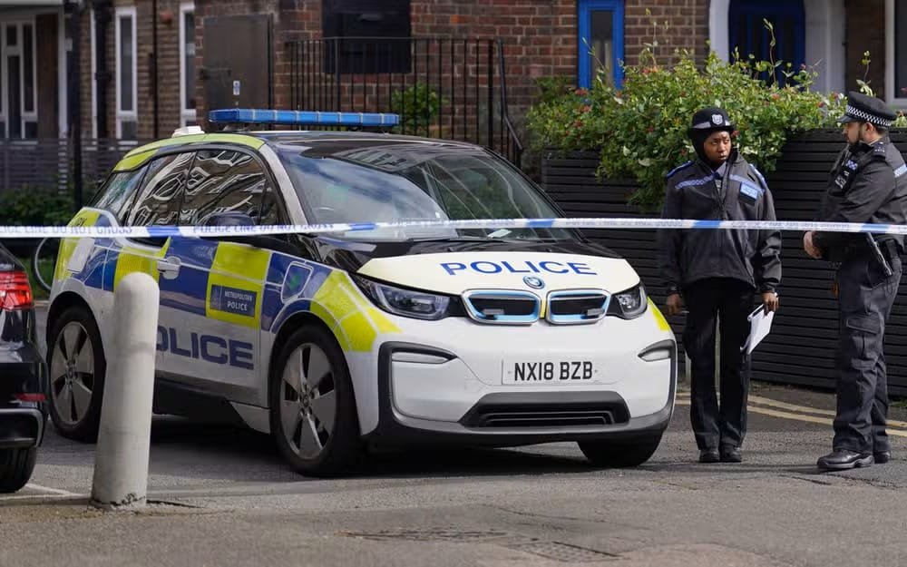 Police near the scene where a woman was found unresponsive in Hackney