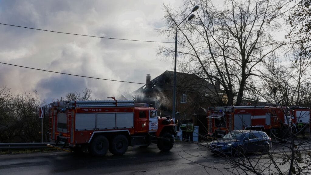 Rescuers stand next to a damaged house following a drone attack in the village of Stanovoye, Moscow region, on Sunday. Tatyana Makeyeva/AFP/Getty Images