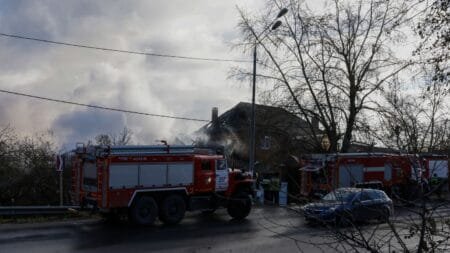 Rescuers stand next to a damaged house following a drone attack in the village of Stanovoye, Moscow region, on Sunday. Tatyana Makeyeva/AFP/Getty Images