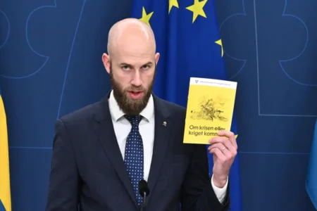 Swedens Minister for Civil Defense Carl Oskar Bohlin shows off the new manual for civilians to be prepared for war or crisis