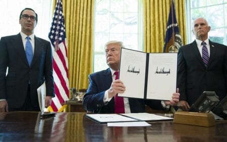 Then US president Donald Trump holds up a signed executive order to increase sanctions on Iran in the Oval Office of the White House June 24 2019 in Washington