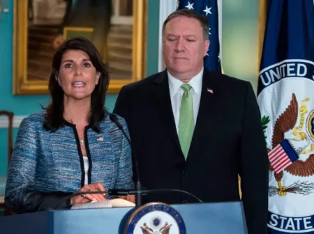 U.S. Secretary of State Mike Pompeo looks on as then-U.S. Ambassador to the United Nations Nikki Haley speaks at the State Department in Washington on June 19, 2018. Andrew Caballero-Reynolds/AFP via Getty Images