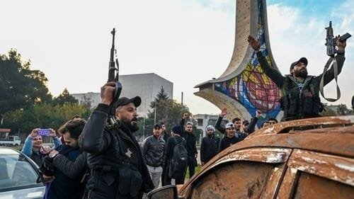 Anti government fighters celebrate at Umayyad Square in Damascus