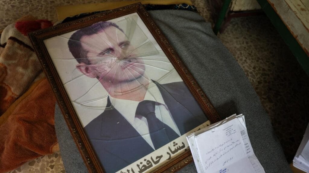 A portrait of Syrian President Bashar al Assad is pictured with its frame broken in a Syrian regimes Political Security Branch facility on the outskirts of the central city of Hama following the capture of the area by anti government forces on December 7 2024 © Omar Haj Kadour AFP