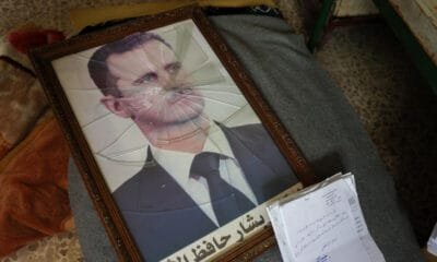 A portrait of Syrian President Bashar al-Assad is pictured with its frame broken, in a Syrian regime's Political Security Branch facility on the outskirts of the central city of Hama, following the capture of the area by anti-government forces, on December 7, 2024. © Omar Haj Kadour, AFP