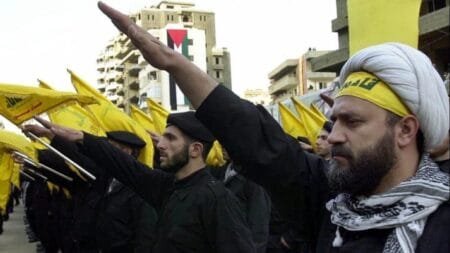Hezbollah fighters take an oath during a parade to continue the path of resistance against Israel