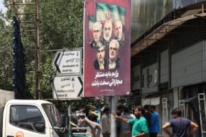 The portraits of Iranian generals and nuclear scientists killed Friday hangs from a lamppost in capital Tehran.AFP via Getty Images