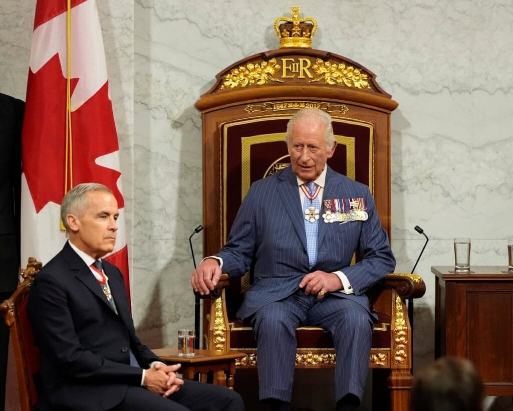 Canadian Prime Minister Mark Carney sits next to King Charles at the Senate of Canada Building in Ottawa, Ontario, Canada May 27, 2025.REUTERS