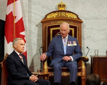 Canadian Prime Minister Mark Carney sits next to King Charles at the Senate of Canada Building in Ottawa, Ontario, Canada May 27, 2025.REUTERS